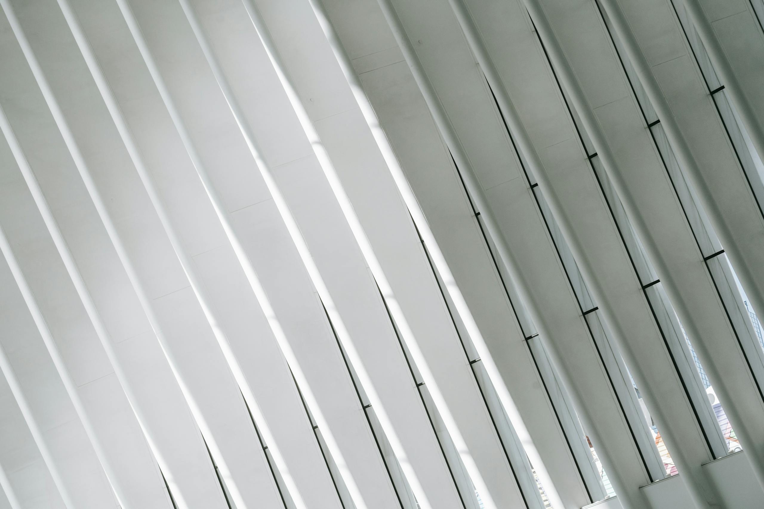 Photo by Laura Tancredi Low angle of geometric white walls with ribs and glass windows in modern minimalist building of terminal in New York